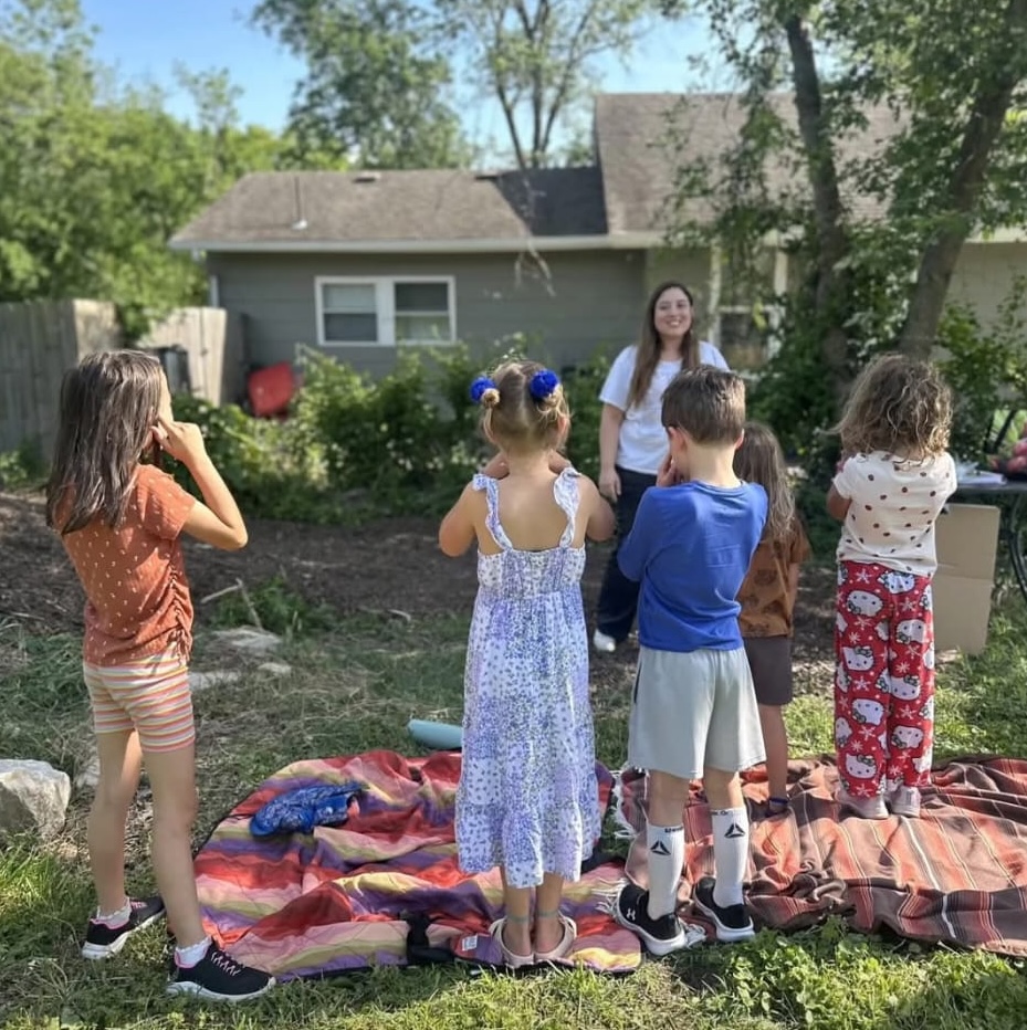 Teacher leading a Spanish lesson with young students.